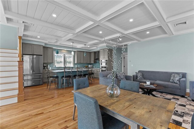 dining space with recessed lighting, coffered ceiling, visible vents, light wood-style floors, and beam ceiling