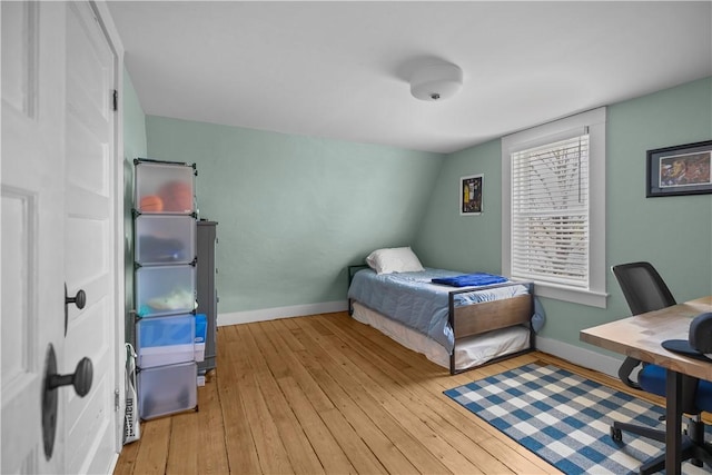 bedroom with baseboards and hardwood / wood-style floors