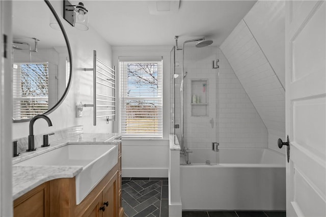 full bathroom with a wealth of natural light, vanity, tile patterned flooring, and bath / shower combo with glass door