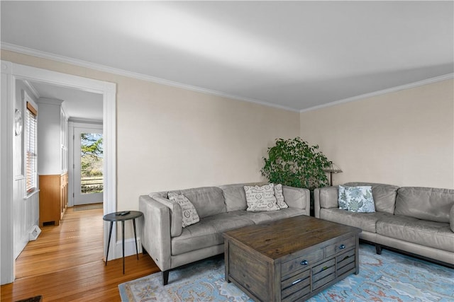 living area featuring light wood finished floors and ornamental molding