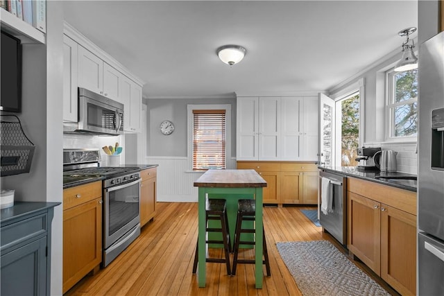 kitchen featuring dark countertops, plenty of natural light, and appliances with stainless steel finishes