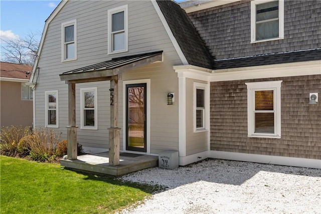 back of property with a gambrel roof and a standing seam roof