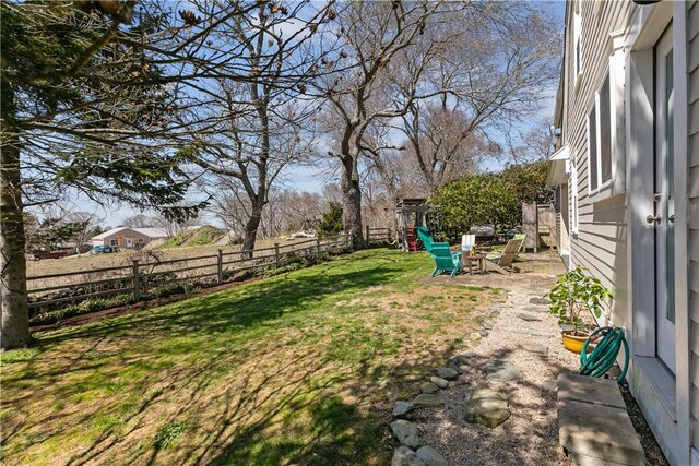 view of yard with a fenced backyard and a playground