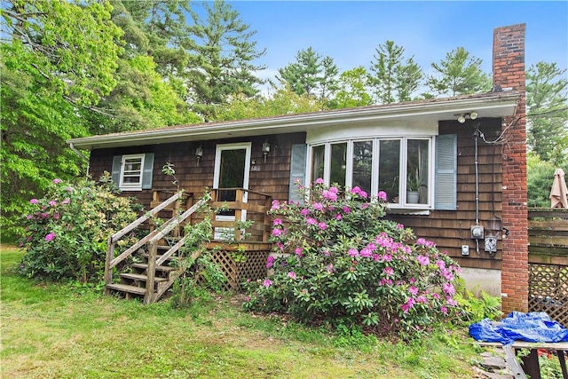 6466 Flat River Rd, Coventry, RI 02827 - view of front of house featuring a chimney, a deck, and a front yard