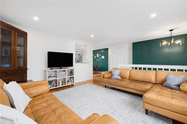 living room with a chandelier, wood finished floors, and recessed lighting