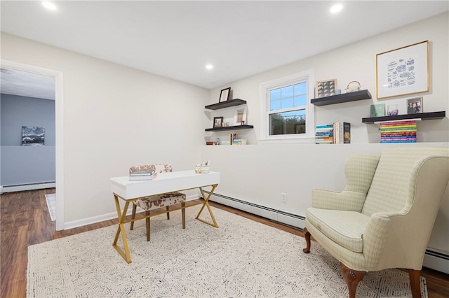office space featuring a baseboard heating unit, wood finished floors, baseboard heating, and recessed lighting