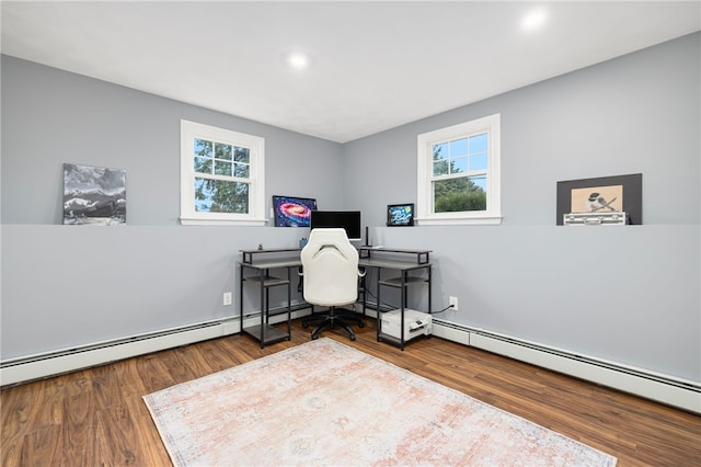 office area with a baseboard heating unit, wood finished floors, a wealth of natural light, and recessed lighting