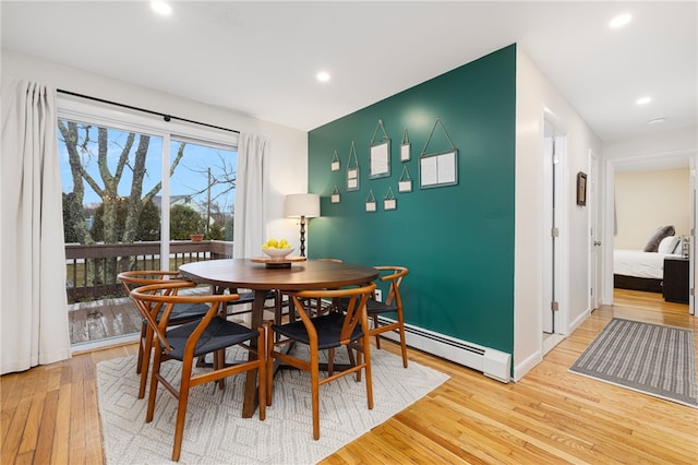 dining space featuring recessed lighting, baseboards, light wood finished floors, and a baseboard heating unit