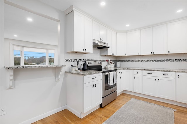 kitchen with light wood finished floors, tasteful backsplash, stainless steel electric range, white cabinetry, and under cabinet range hood