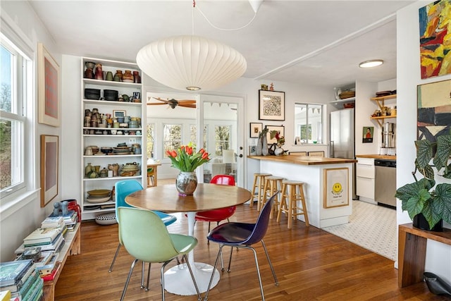 dining area featuring light wood-style floors and ceiling fan