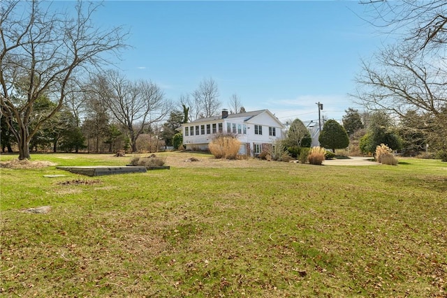 rear view of property with a lawn