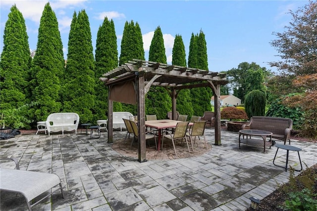 view of patio / terrace with a pergola, outdoor dining space, and an outdoor fire pit
