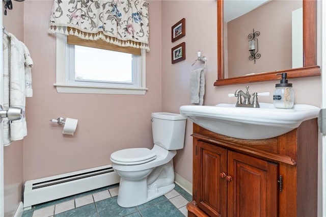 bathroom featuring baseboard heating, vanity, baseboards, toilet, and tile patterned flooring