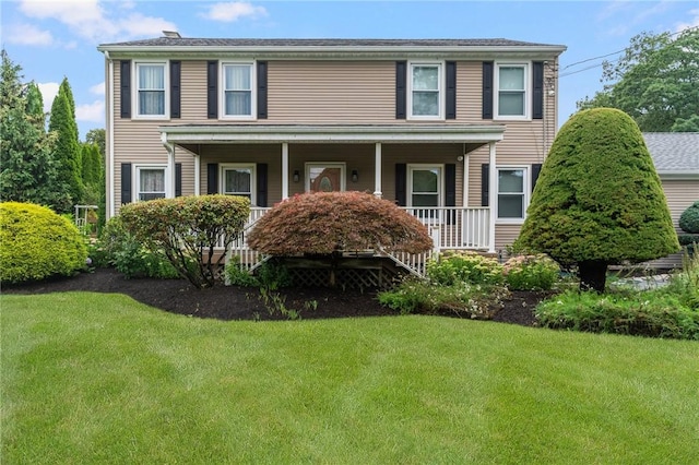 colonial home with a front lawn and covered porch