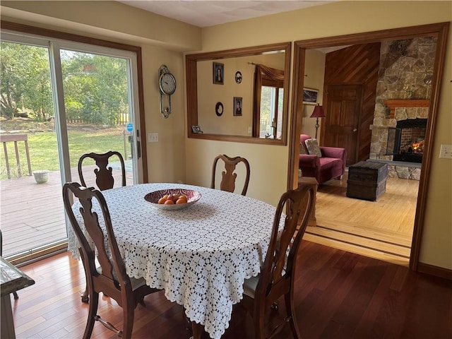 dining room with hardwood / wood-style flooring and a fireplace