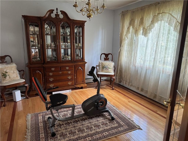 sitting room featuring light wood-style flooring and an inviting chandelier