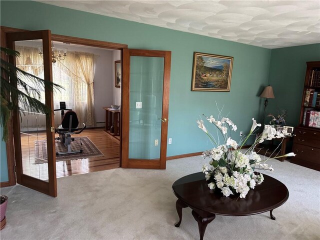 living area featuring baseboards and carpet flooring