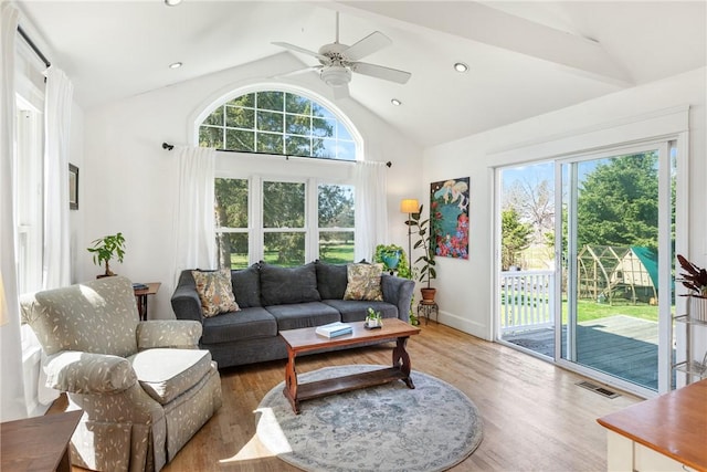 living room featuring wood finished floors, visible vents, and plenty of natural light