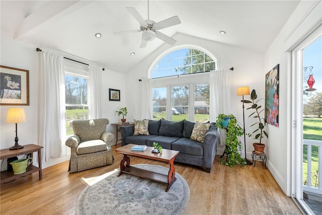 living room featuring a ceiling fan, light wood-type flooring, and plenty of natural light