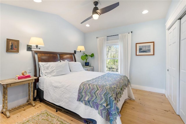 bedroom featuring recessed lighting, vaulted ceiling, wood finished floors, a closet, and baseboards