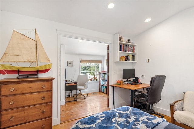 bedroom with baseboards, recessed lighting, and light wood-style floors
