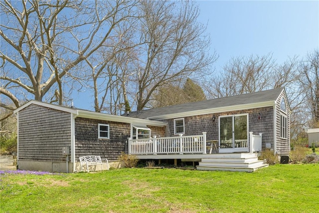 back of property with a yard and a deck