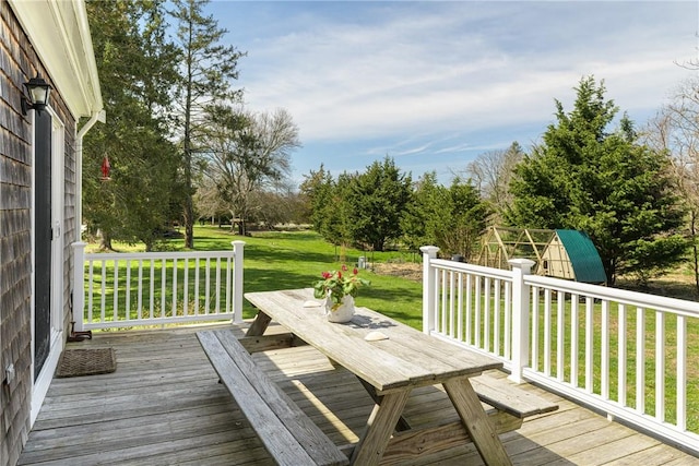 wooden deck with a lawn