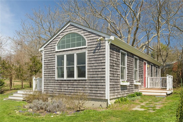 view of property exterior with a lawn