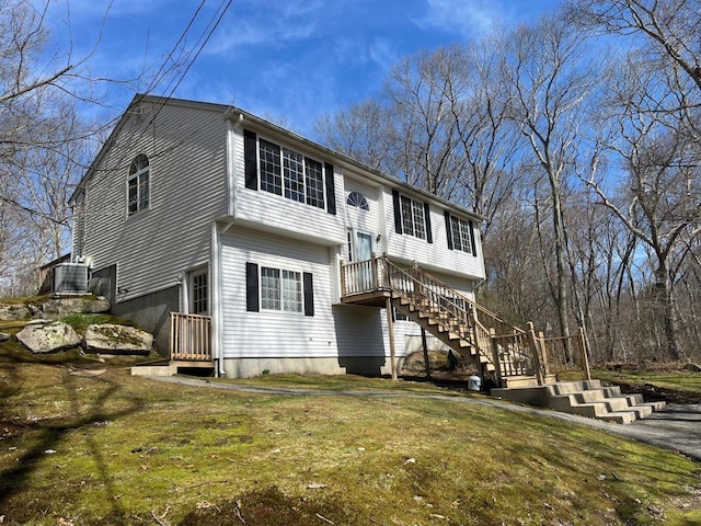 view of front facade featuring a front yard and stairway