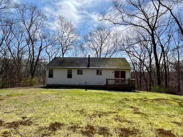 back of property featuring a yard and a deck