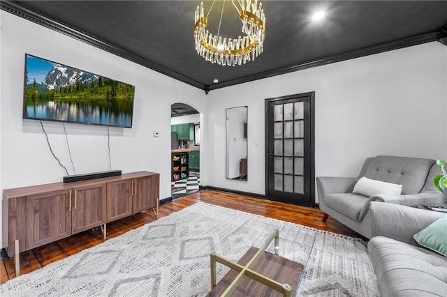 134 Courtland St, Providence, RI 02909 - living room featuring arched walkways, crown molding, a chandelier, and wood finished floors
