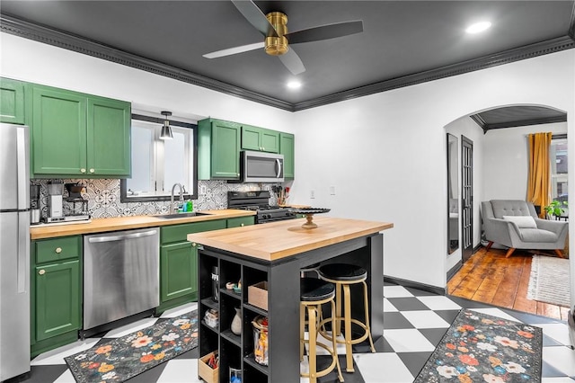 134 Courtland St, Providence, RI 02909 - kitchen featuring wood counters, stainless steel appliances, green cabinetry, crown molding, and light flooring