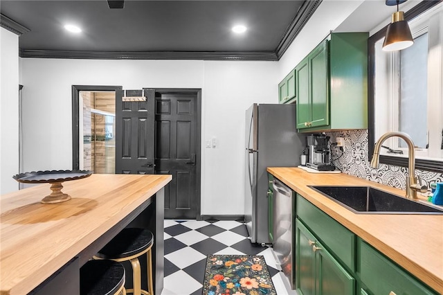 134 Courtland St, Providence, RI 02909 - kitchen featuring green cabinets, dark flooring, a sink, butcher block countertops, and appliances with stainless steel finishes