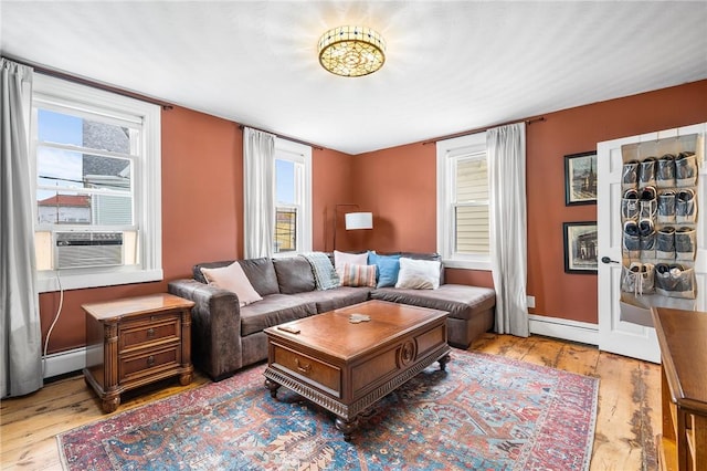 134 Courtland St, Providence, RI 02909 - living room with a baseboard heating unit, wood finished floors, cooling unit, baseboards, and a baseboard radiator