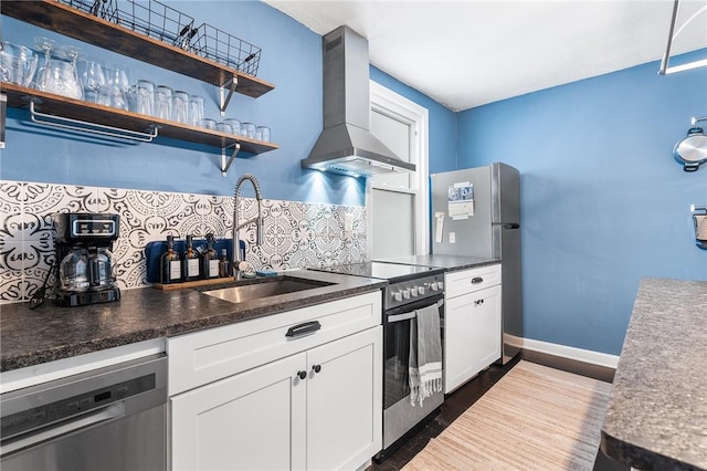 134 Courtland St, Providence, RI 02909 - kitchen featuring appliances with stainless steel finishes, wall chimney range hood, a sink, tasteful backsplash, and dark countertops