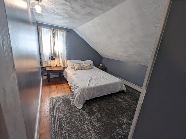 134 Courtland St, Providence, RI 02909 - bedroom featuring vaulted ceiling, a baseboard heating unit, hardwood / wood-style floors, and baseboards