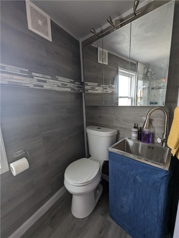 134 Courtland St, Providence, RI 02909 - full bath featuring toilet, a shower, vanity, tile walls, and wood finished floors