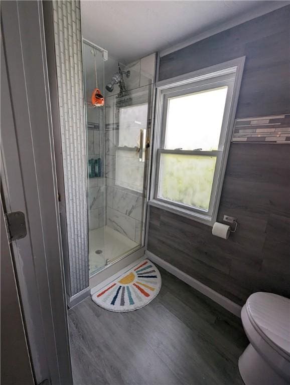 134 Courtland St, Providence, RI 02909 - full bath featuring a stall shower, wood finished floors, toilet, and baseboards