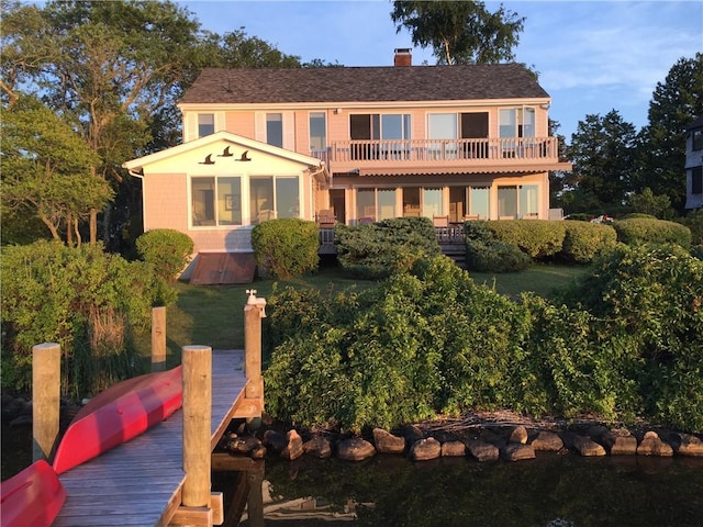 183 Twin Peninsula Ave, South Kingstown, RI 02879 - rear view of property featuring a chimney
