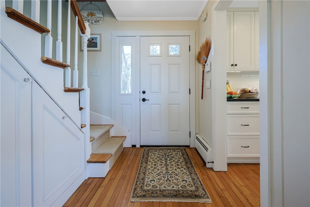 183 Twin Peninsula Ave, South Kingstown, RI 02879 - foyer featuring a baseboard radiator, light wood-style flooring, crown molding, and stairs