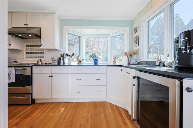 183 Twin Peninsula Ave, South Kingstown, RI 02879 - kitchen with beverage cooler, under cabinet range hood, a sink, stainless steel electric range, and dark countertops