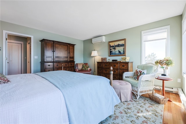 183 Twin Peninsula Ave, South Kingstown, RI 02879 - bedroom with a wall mounted air conditioner, light wood-style floors, and a baseboard radiator