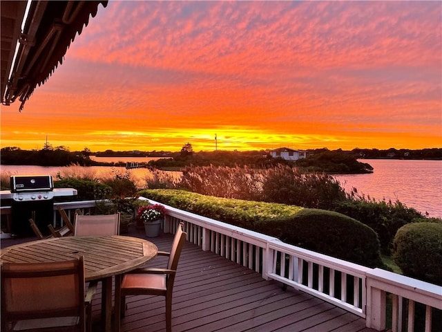 183 Twin Peninsula Ave, South Kingstown, RI 02879 - deck at dusk featuring grilling area, a water view, and outdoor dining area