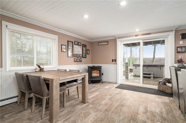 465 Camp Dixie Rd, Burrillville, RI 02859 - dining area featuring wainscoting, a wealth of natural light, and a wood stove