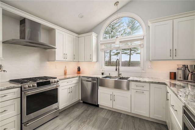 465 Camp Dixie Rd, Burrillville, RI 02859 - kitchen with appliances with stainless steel finishes, tasteful backsplash, a sink, lofted ceiling, and wall chimney exhaust hood