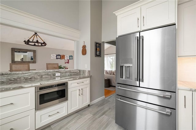 465 Camp Dixie Rd, Burrillville, RI 02859 - kitchen with baseboards, appliances with stainless steel finishes, white cabinets, and light stone countertops