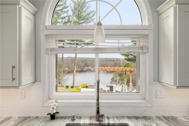 465 Camp Dixie Rd, Burrillville, RI 02859 - interior details with a sink, a water view, tasteful backsplash, and light stone counters
