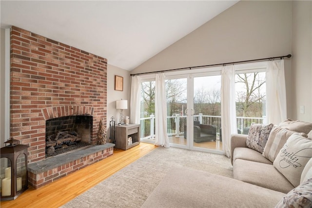 465 Camp Dixie Rd, Burrillville, RI 02859 - living area with high vaulted ceiling, a wealth of natural light, wood finished floors, and a fireplace