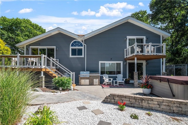 465 Camp Dixie Rd, Burrillville, RI 02859 - back of property with a balcony, area for grilling, stairs, a patio area, and a hot tub