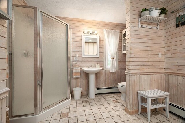 465 Camp Dixie Rd, Burrillville, RI 02859 - bathroom featuring wooden walls, toilet, baseboard heating, and a stall shower